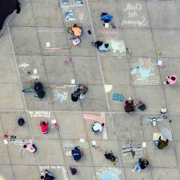 Aerial view from a drone of 学生s participating in Chalk Art Symposium